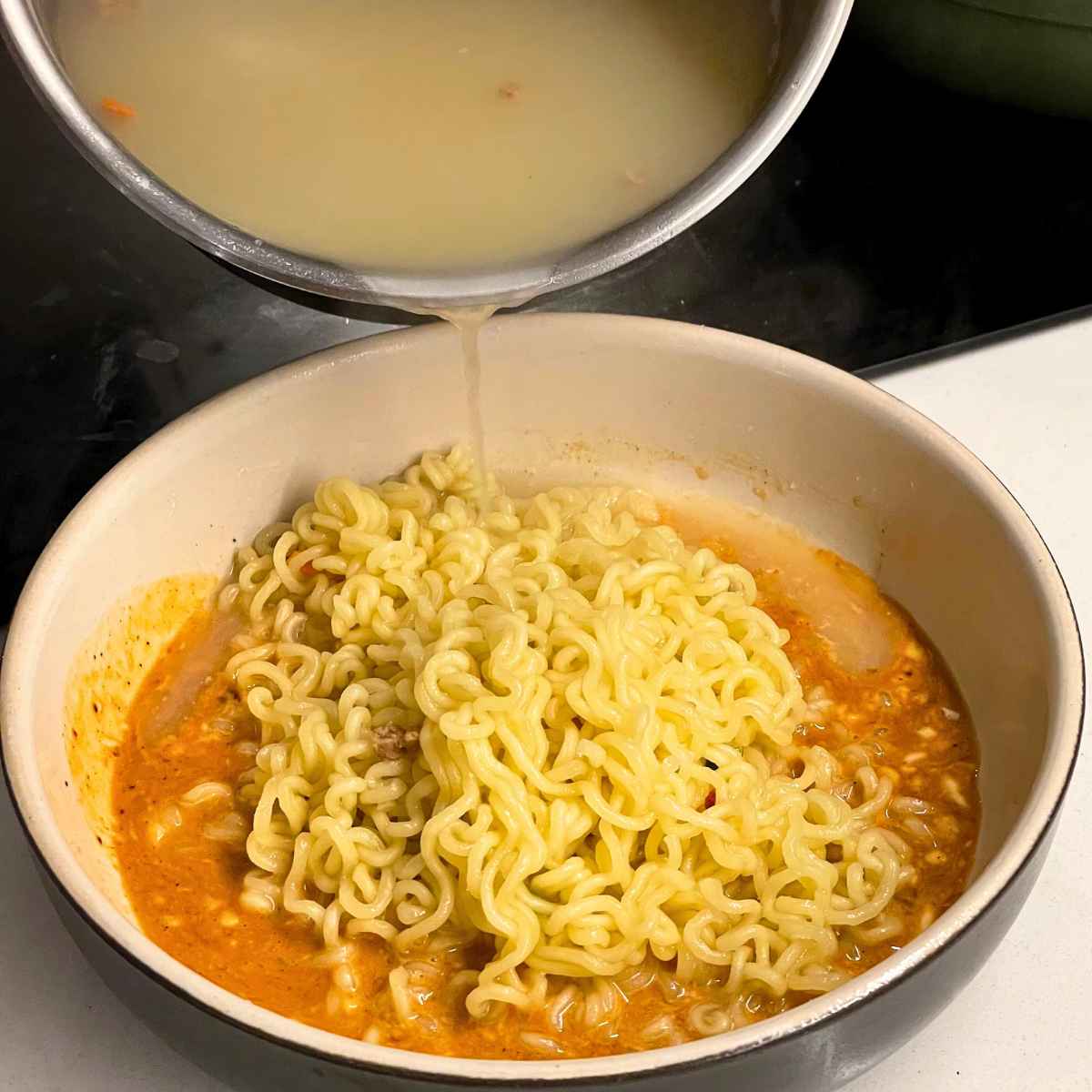 Add noodle water to make creamy ramen noodles