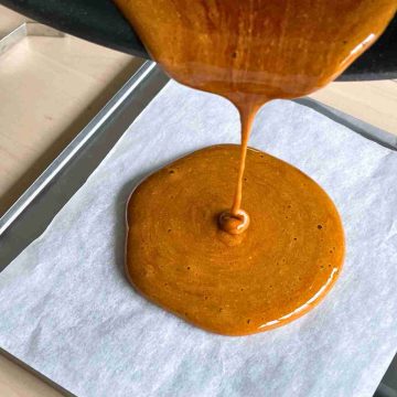 pour dalgona candy onto parchment paper