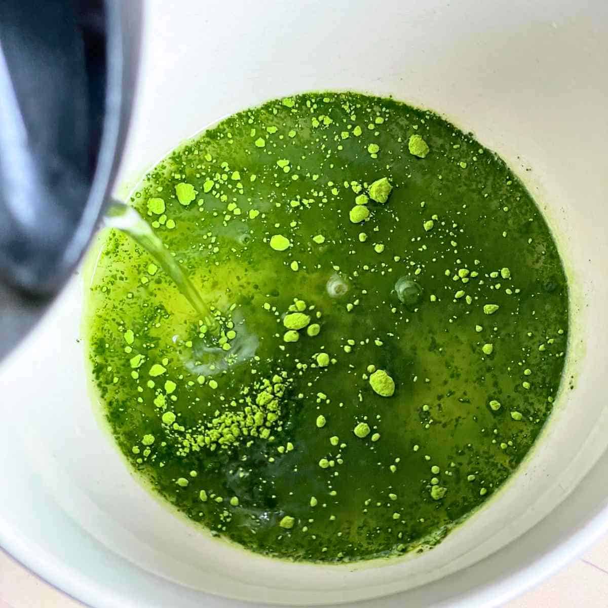 pour hot water into matcha powder