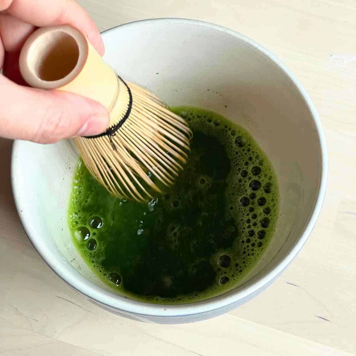 whisking matcha to mix in drinks